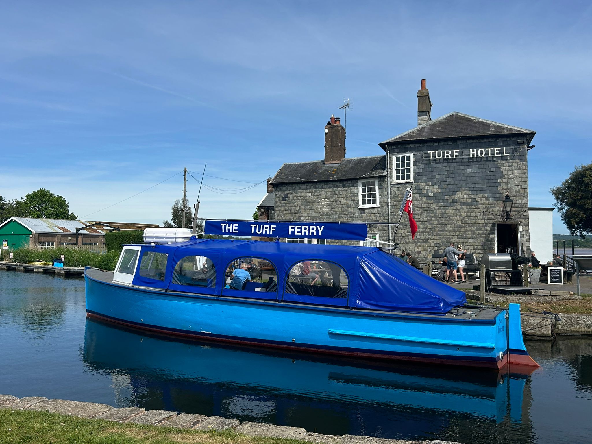 The Turf Ferry sits on the water in front of the pub.